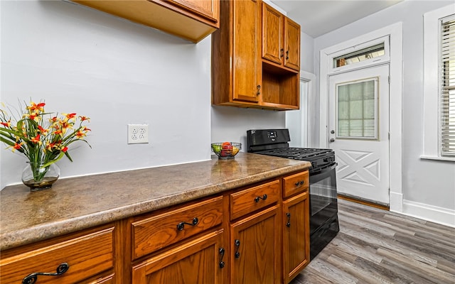 kitchen featuring black gas stove and light hardwood / wood-style floors