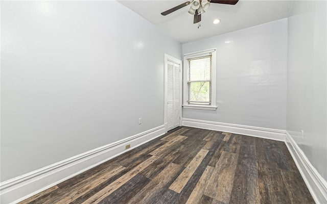 empty room featuring ceiling fan and dark hardwood / wood-style flooring