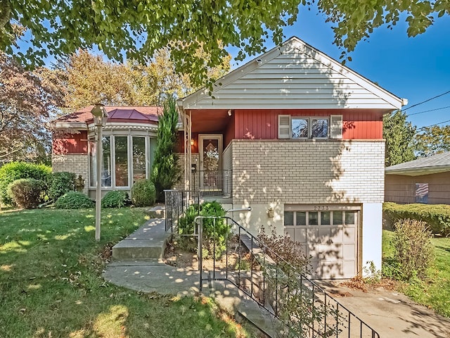 view of front facade with a front yard and a garage