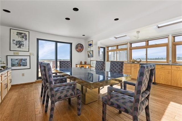 dining room featuring light hardwood / wood-style floors and ceiling fan