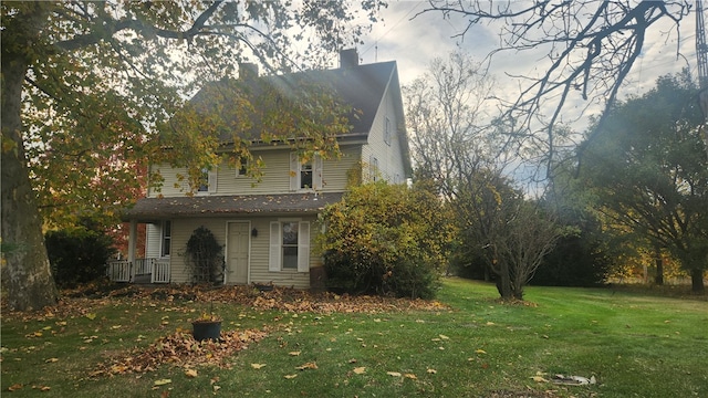 view of side of property with a lawn