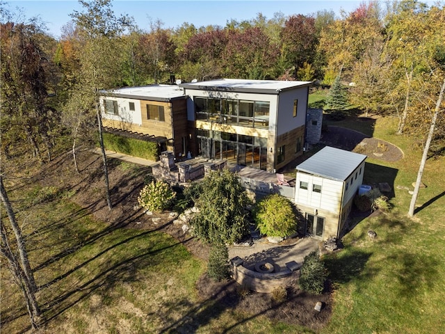 rear view of property with a yard and a patio area