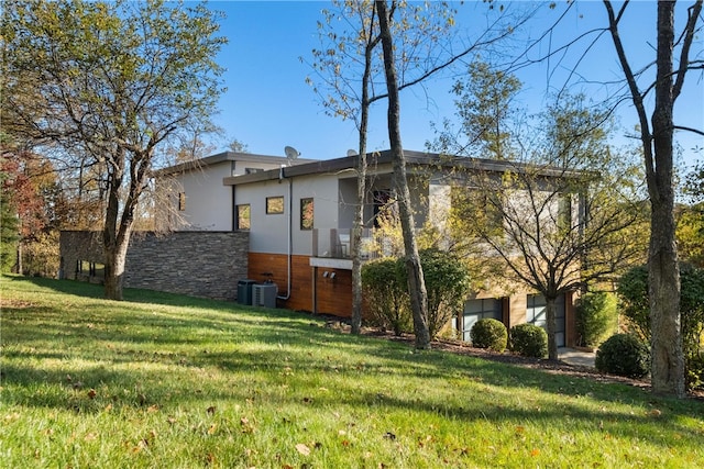 exterior space featuring central AC and a yard