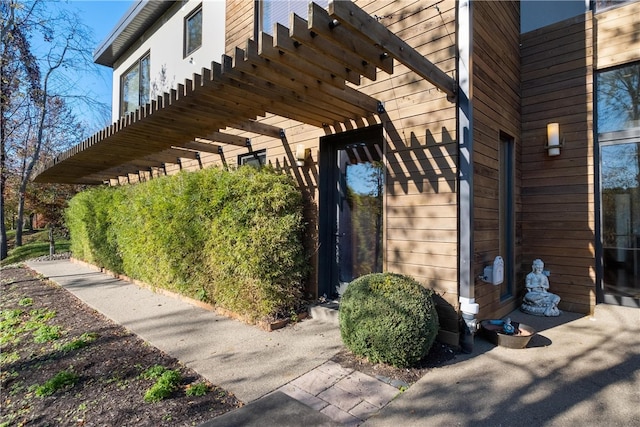 view of side of home with a pergola