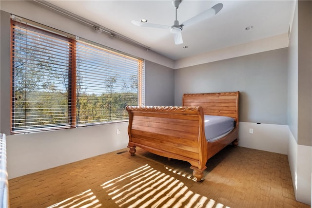 bedroom featuring ceiling fan and hardwood / wood-style flooring