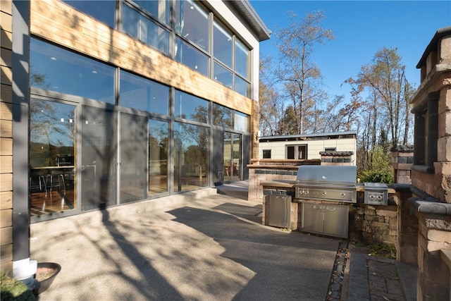 view of patio featuring exterior kitchen and grilling area