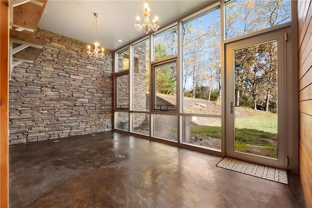 unfurnished sunroom featuring a notable chandelier