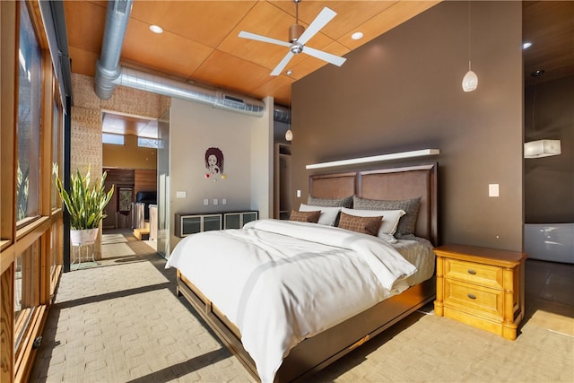 bedroom with a towering ceiling and ceiling fan