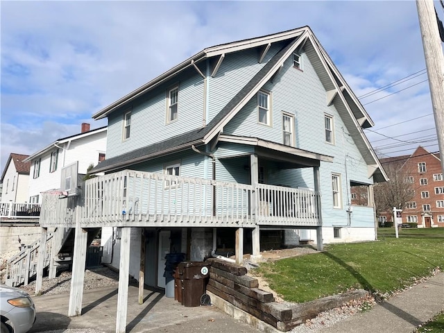 rear view of property with a lawn and a deck