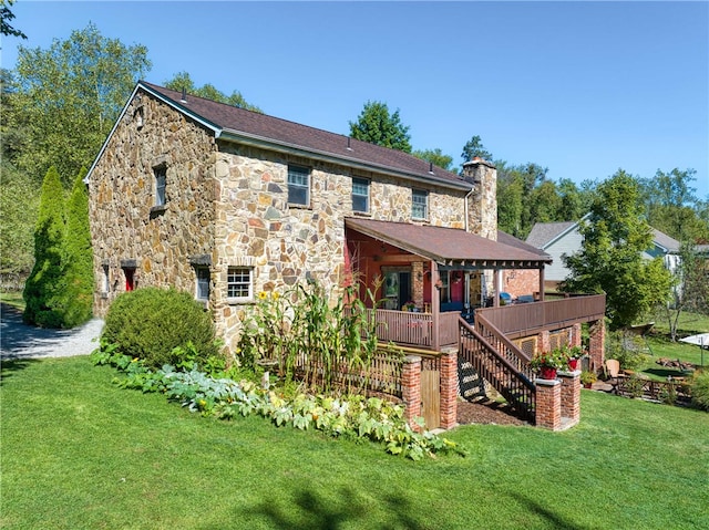 rear view of property with a lawn