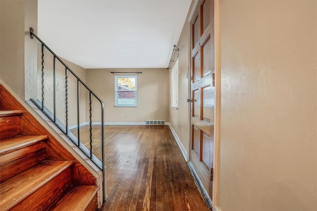 entrance foyer with dark hardwood / wood-style floors