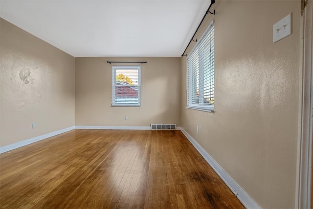 unfurnished room featuring hardwood / wood-style floors