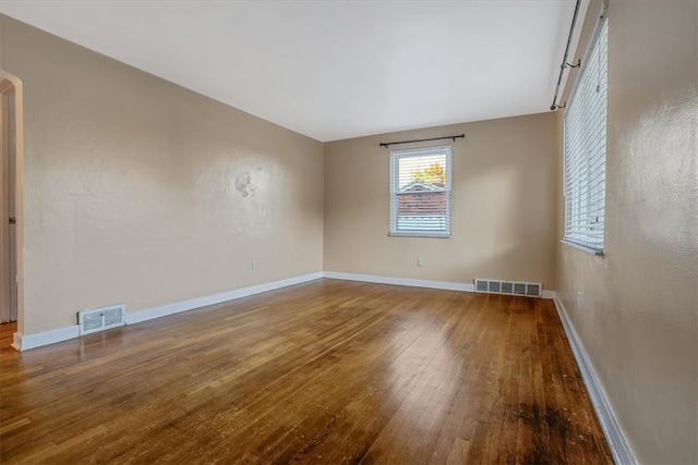 unfurnished room with wood-type flooring