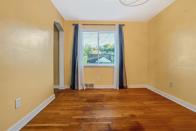 unfurnished room featuring hardwood / wood-style flooring