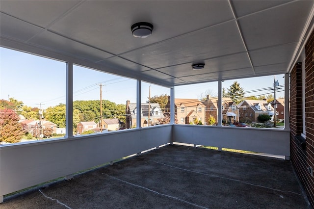 unfurnished sunroom with a drop ceiling