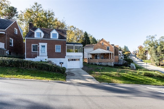 view of front of home with a front lawn and a garage