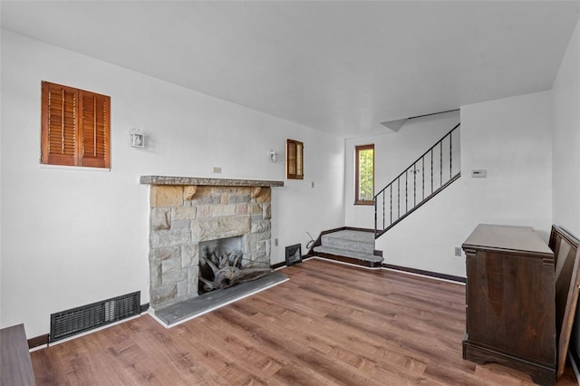 unfurnished living room featuring hardwood / wood-style flooring and a fireplace