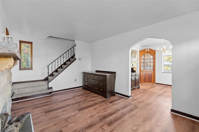 living room featuring hardwood / wood-style flooring and an inviting chandelier