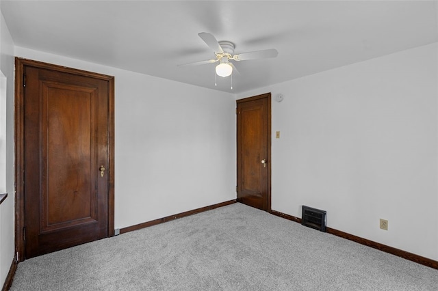 empty room with carpet flooring and ceiling fan