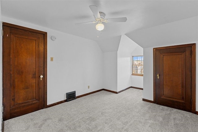 bonus room with ceiling fan, light colored carpet, and vaulted ceiling