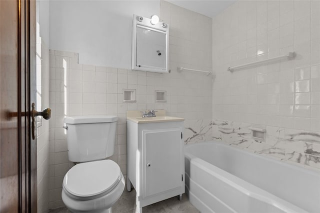 bathroom with vanity, toilet, tile walls, and a bath