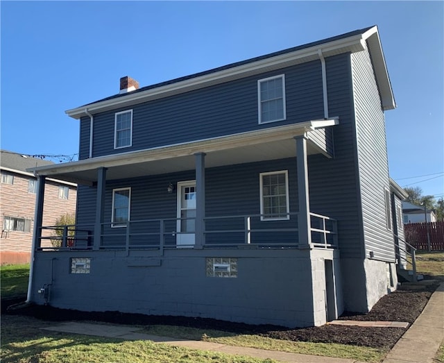 rear view of house featuring a porch