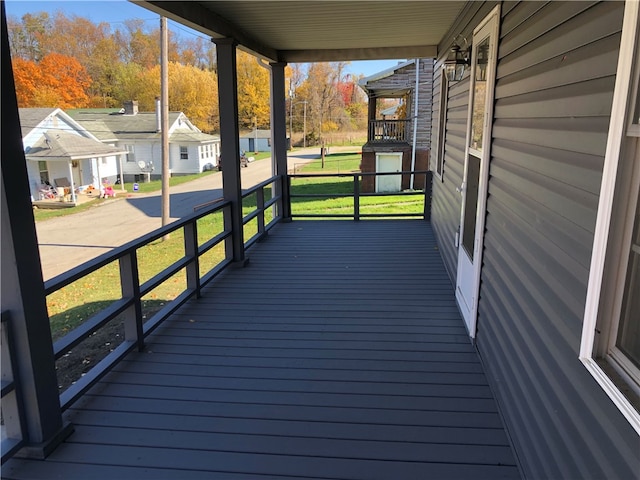 deck with a porch and a lawn