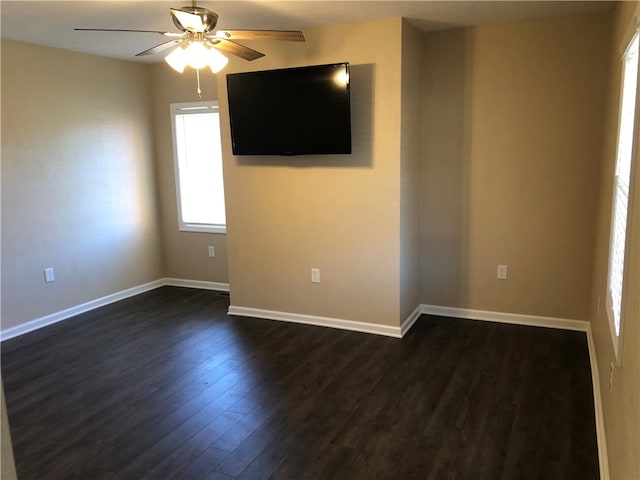 unfurnished room with ceiling fan and dark hardwood / wood-style floors