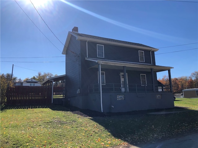 exterior space featuring covered porch and a yard