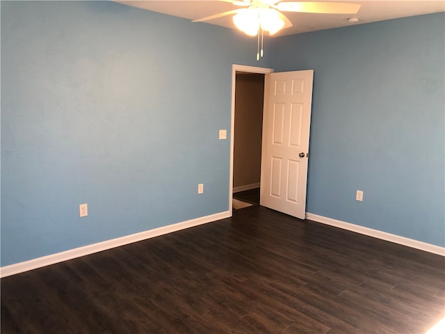 spare room with ceiling fan and dark hardwood / wood-style floors