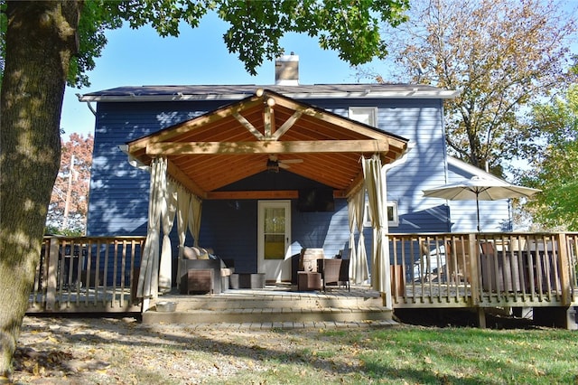 back of house featuring a deck