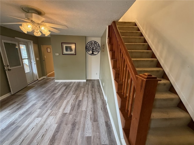 entrance foyer featuring a textured ceiling, light wood-type flooring, and ceiling fan