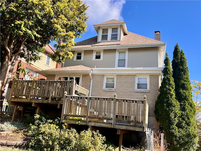 rear view of house featuring a deck