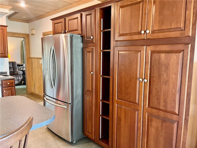 kitchen featuring wood ceiling and stainless steel refrigerator