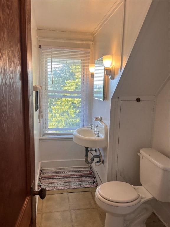 bathroom featuring tile patterned floors, toilet, and ornamental molding