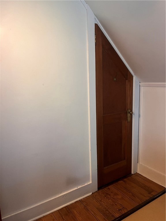 corridor with hardwood / wood-style flooring