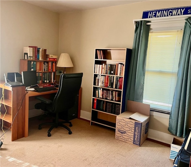 home office featuring a healthy amount of sunlight and light colored carpet