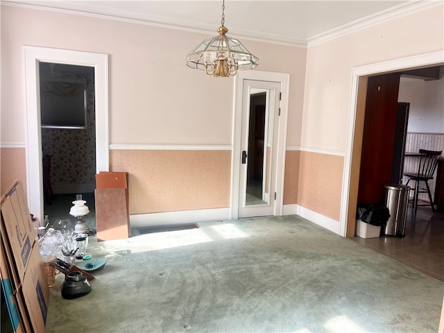 spare room with a notable chandelier and crown molding