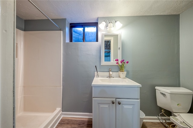 bathroom with walk in shower, toilet, a textured ceiling, and hardwood / wood-style flooring