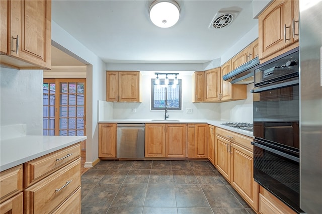 kitchen featuring dark tile patterned floors, sink, and stainless steel appliances