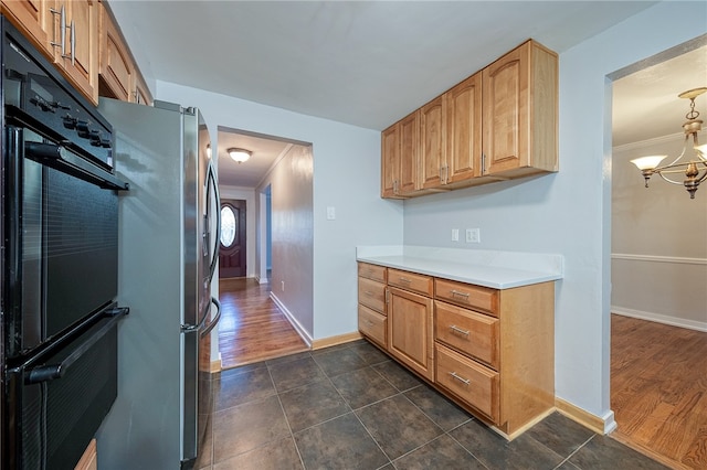 kitchen featuring a notable chandelier, double oven, dark hardwood / wood-style floors, and crown molding