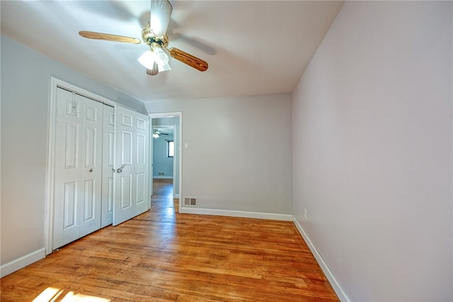 unfurnished bedroom with light hardwood / wood-style floors, ceiling fan, and a closet