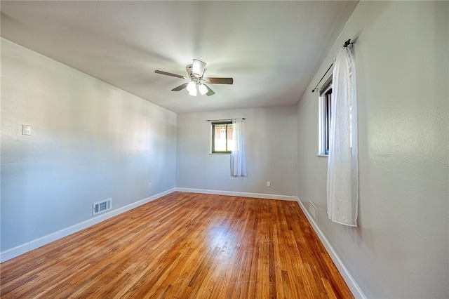 unfurnished room with hardwood / wood-style flooring and ceiling fan