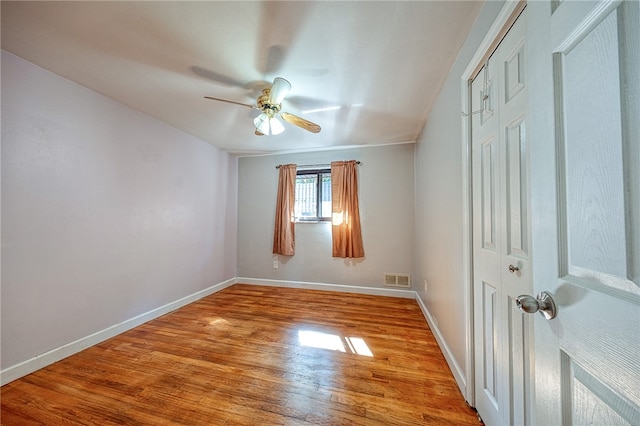 spare room with hardwood / wood-style flooring and ceiling fan