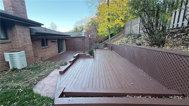 wooden deck featuring central AC unit