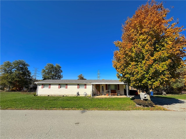 view of front of home with a front yard and covered porch