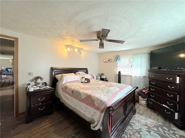 bedroom with wood-type flooring and ceiling fan