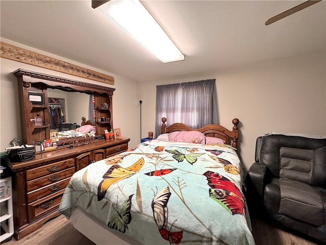 bedroom with light hardwood / wood-style floors and ceiling fan