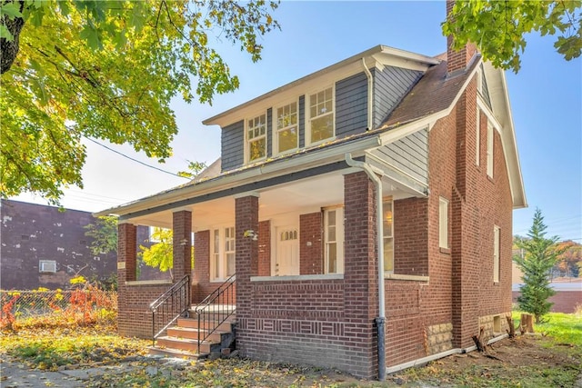 563 Coleman Ave, Greater Johnstown School District, PA 15902 - bungalow with fence, a chimney, and brick siding