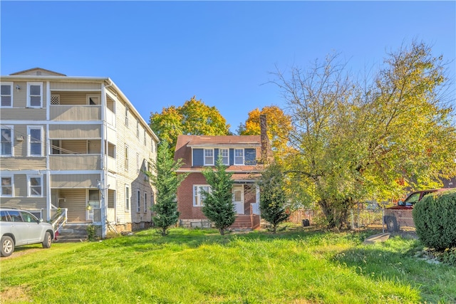 view of front of property with a front lawn and a balcony